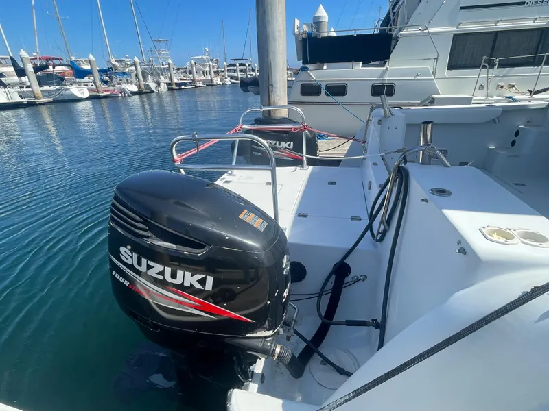 Slide: The Image of 2004 Glacier Bay Ocean Runner 3470 with Suzuki outboard motor docked at marina. - 10