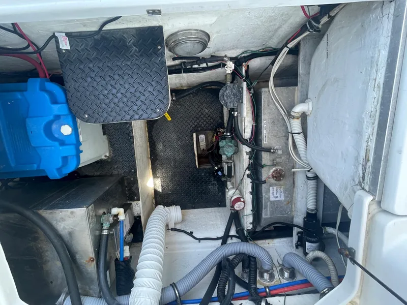 Slide: The Image of Engine compartment of a 2004 Glacier Bay Ocean Runner 3470 with visible wiring and components. - 11
