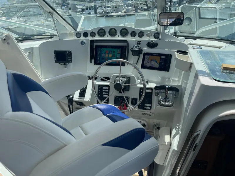 Slide: The Image of 2004 Glacier Bay Ocean Runner 3470 cockpit with steering wheel, navigation screens, and control panel. - 16