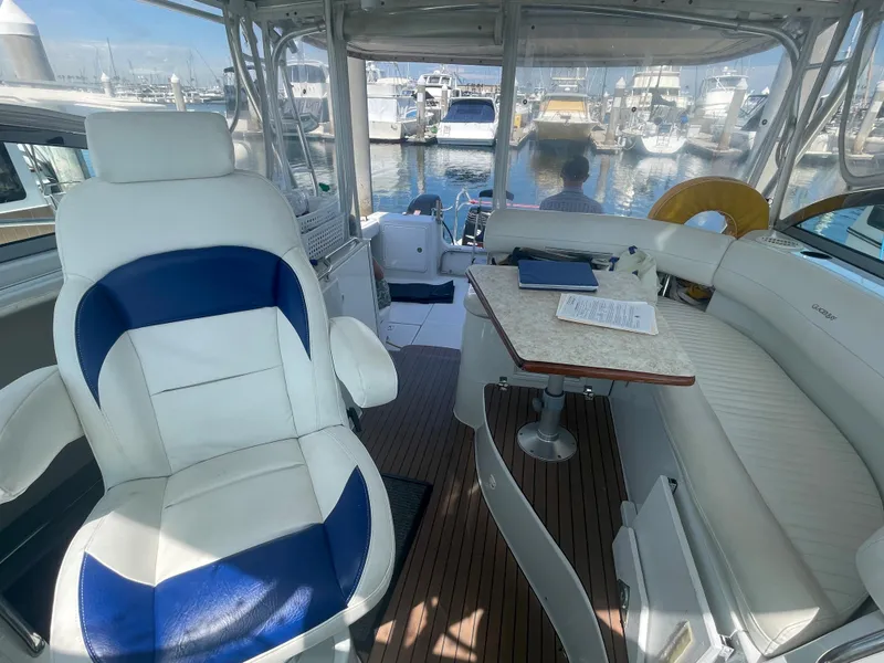 Slide: The Image of 2004 Glacier Bay Ocean Runner 3470 interior with white seating and marina view. - 18
