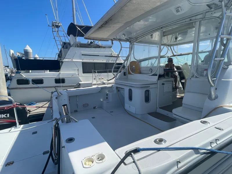 Slide: The Image of 2004 Glacier Bay Ocean Runner 3470 boat docked at marina, featuring spacious deck and seating area. - 19