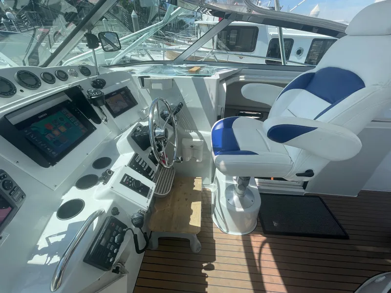 Slide: The Image of Helm of 2004 Glacier Bay Ocean Runner 3470 with modern controls and blue-white captain's chair. - 22