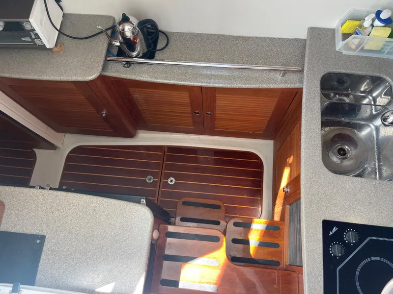 Slide: The Image of Interior of 2004 Glacier Bay Ocean Runner 3470, featuring kitchen area with sink and stove. - 31