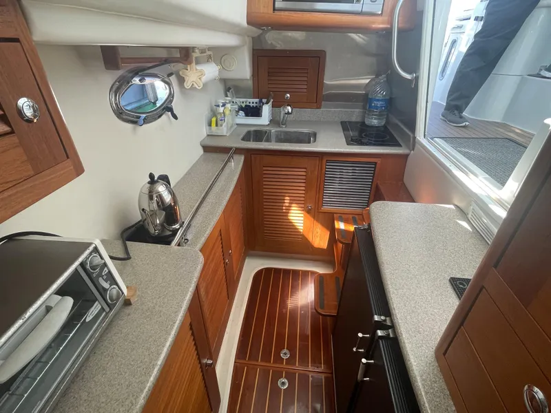Slide: The Image of 2004 Glacier Bay Ocean Runner 3470 yacht kitchen with wooden cabinets and modern appliances. - 36