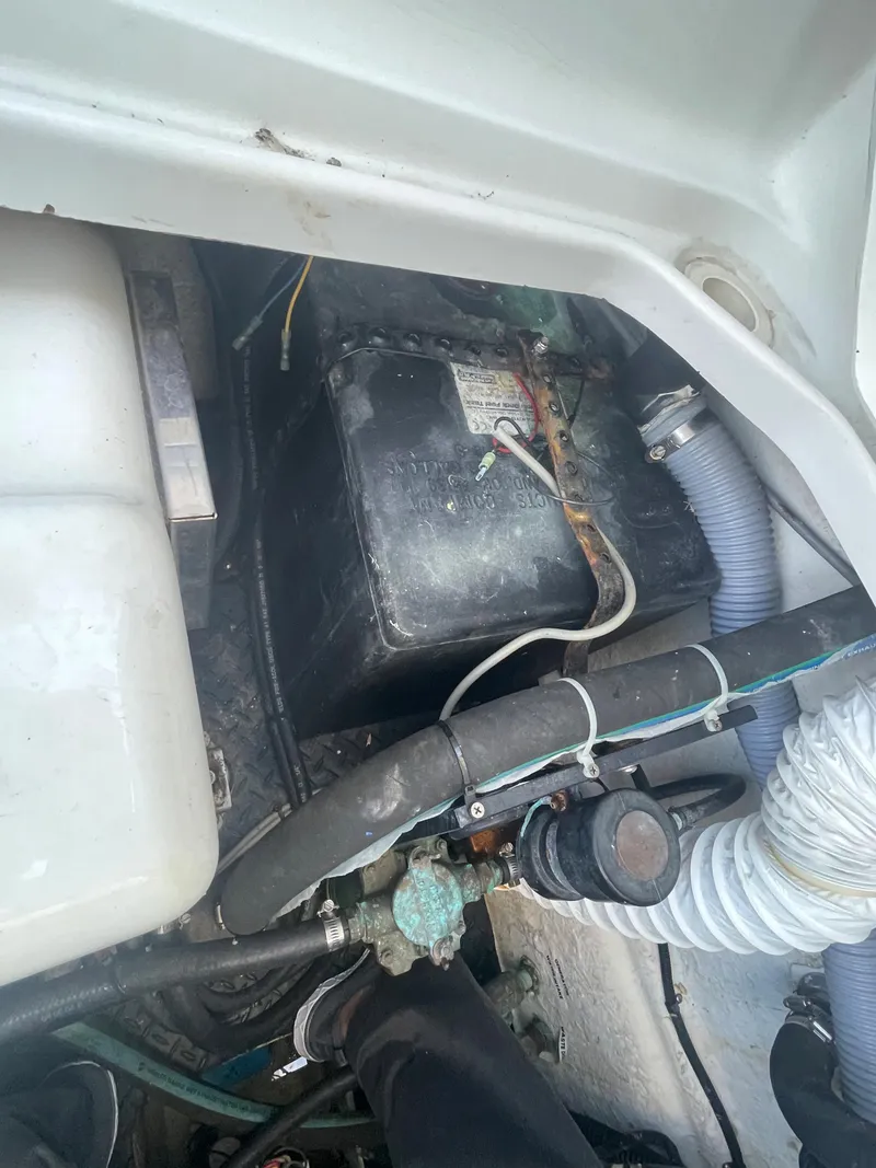 Slide: The Image of 2004 Glacier Bay Ocean Runner 3470 engine compartment with battery and hoses. - 39