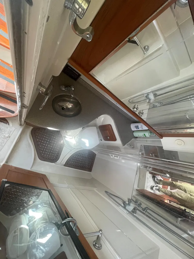 Slide: The Image of Interior of 2004 Glacier Bay Ocean Runner 3470, featuring a compact bathroom and sink area. - 43