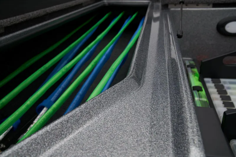 Slide: The Image of 2024 Nitro Z20 Pro fishing rod storage compartment with organized rods. - 20