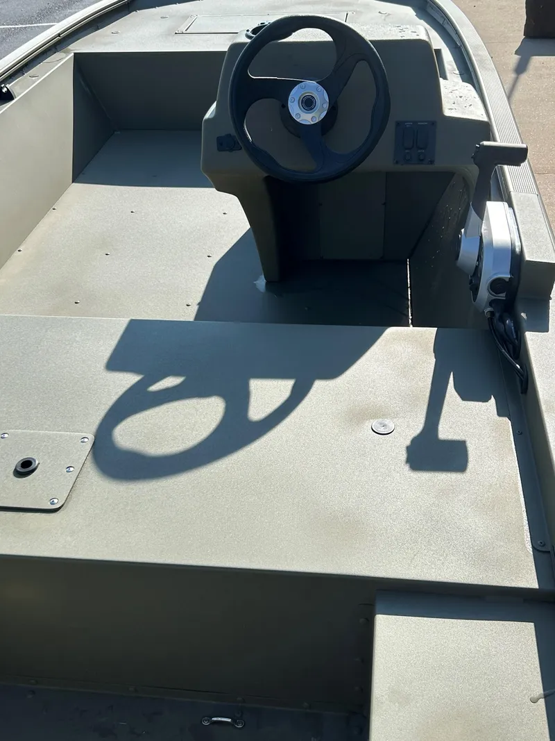 Slide: The Image of 2024 Tracker Grizzly 1648 SC boat interior with steering console. - 3