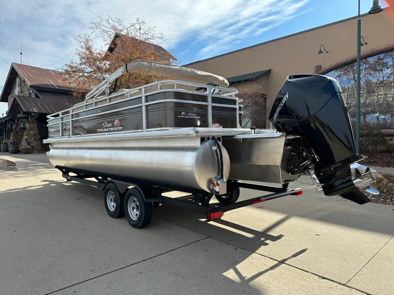 Slide: The Image of 2024 Sun Tracker Sportfish 24 XP3 pontoon boat on a trailer. - 2