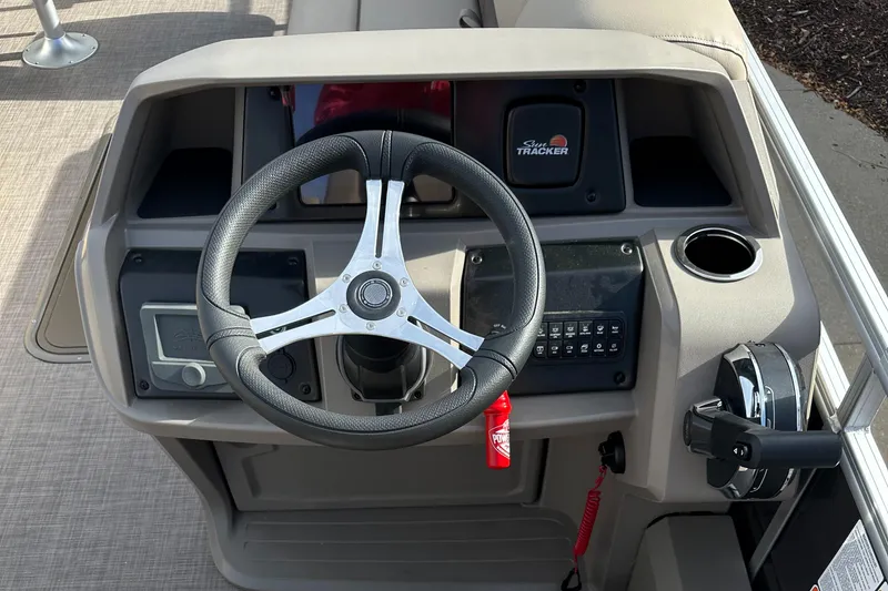 Slide: The Image of 2024 Sun Tracker Sportfish 24 XP3 steering console with modern controls and cup holder. - 3