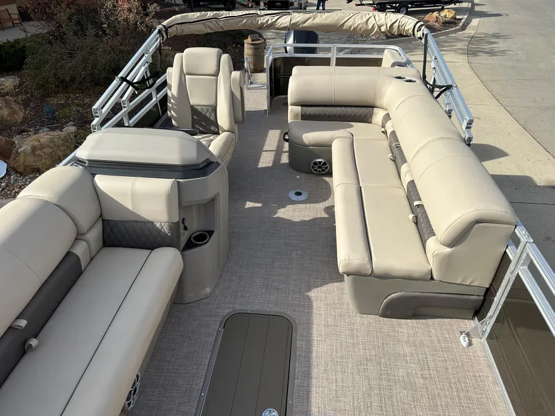 Slide: The Image of 2024 Sun Tracker Sportfish 24 XP3 pontoon boat interior with beige seating. - 4