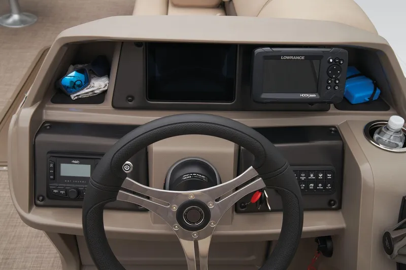 Slide: The Image of Dashboard of 2024 Sun Tracker Sportfish 24 XP3 with steering wheel and Lowrance fishfinder. - 42