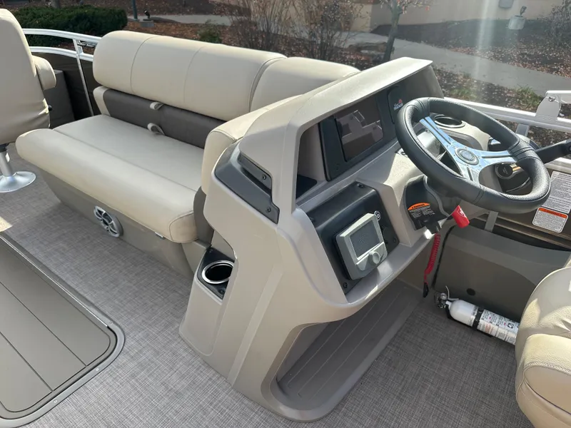 Slide: The Image of 2024 Sun Tracker Sportfish 24 XP3 boat interior with steering console and seating. - 6