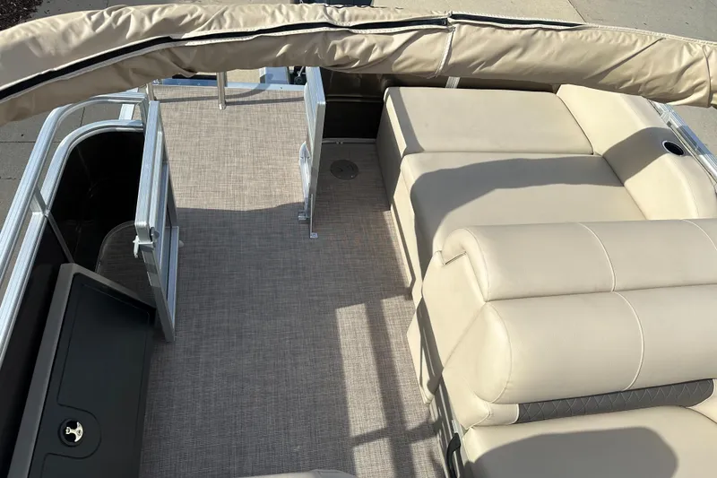 Slide: The Image of 2024 Sun Tracker Sportfish 24 XP3 interior with beige seating and carpeted floor. - 7