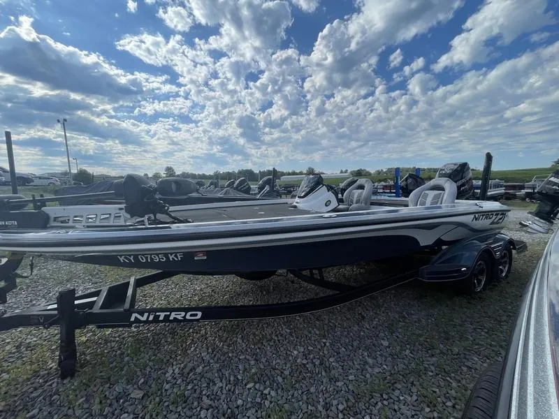 The Image of 2017 Nitro Z21 boat on a trailer under a partly cloudy sky. - 1