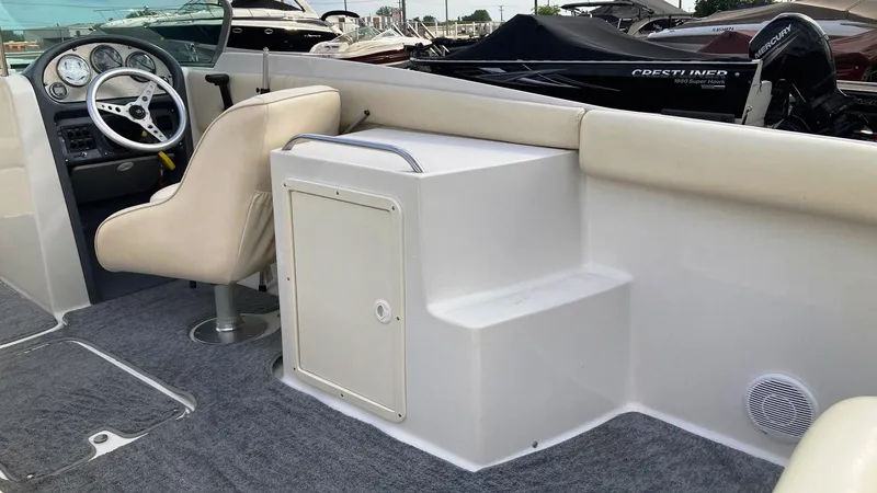Slide: The Image of 2001 Chris-Craft Launch 25 boat interior with helm, seating, and storage compartment. - 10
