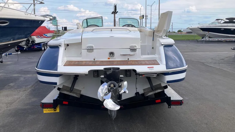Slide: The Image of 2001 Chris-Craft Launch 25 boat on trailer, rear view, marina background. - 3