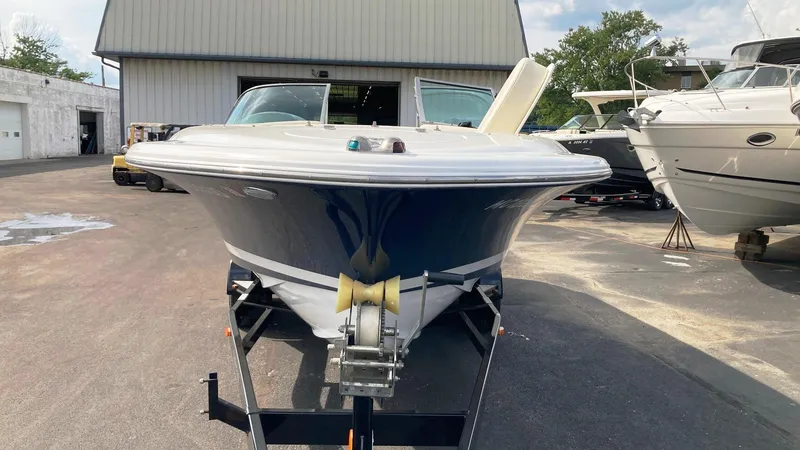 Slide: The Image of 2001 Chris-Craft Launch 25 boat on trailer in a marina. - 4