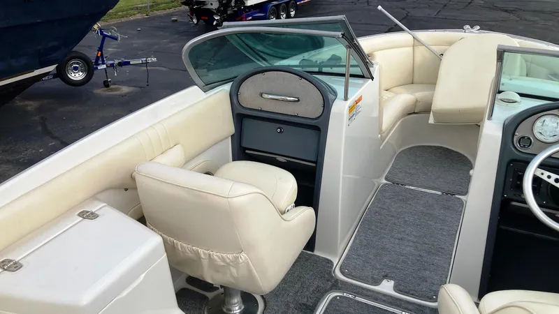 Slide: The Image of 2001 Chris-Craft Launch 25 boat interior with beige seating and dashboard. - 5