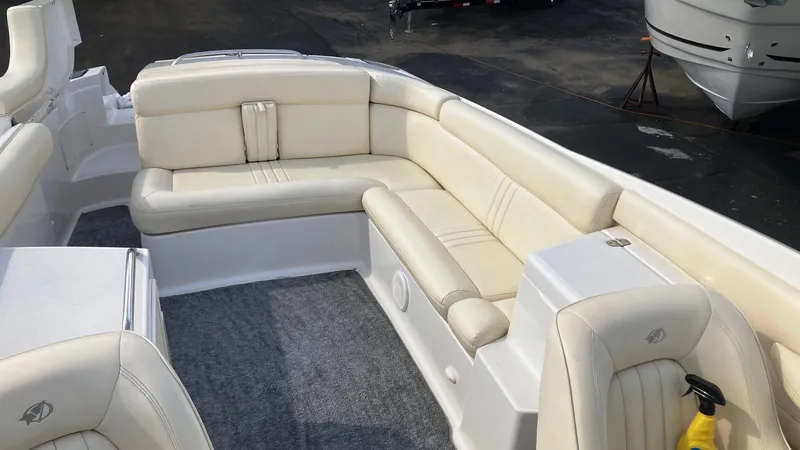 Slide: The Image of 2001 Chris-Craft Launch 25 boat interior with beige leather seating and gray carpet. - 9