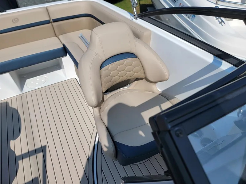 Slide: The Image of 2024 Hurricane SunDeck 217 OB boat interior with beige and blue seating. - 10