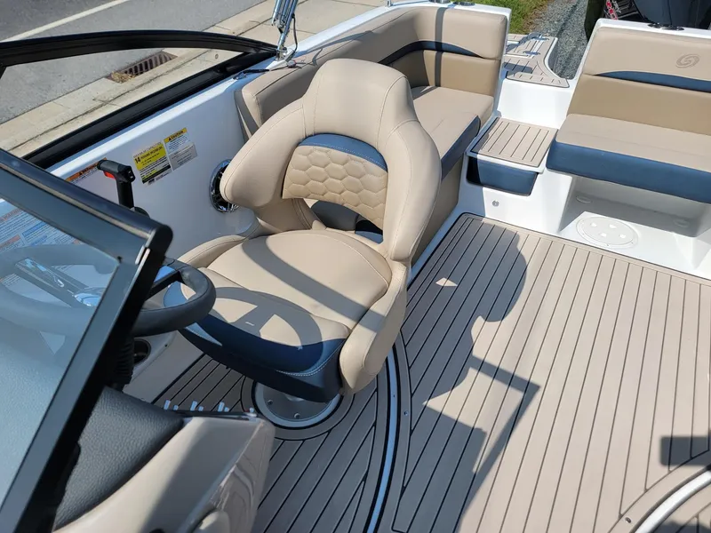 Slide: The Image of 2024 Hurricane SunDeck 217 OB boat interior with beige and navy seating. - 11