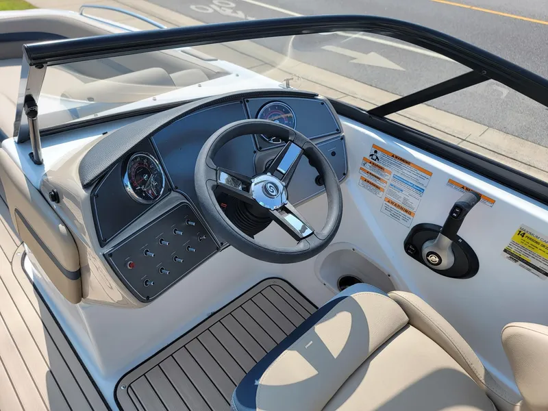Slide: The Image of 2024 Hurricane SunDeck 217 OB boat dashboard and steering wheel. - 12