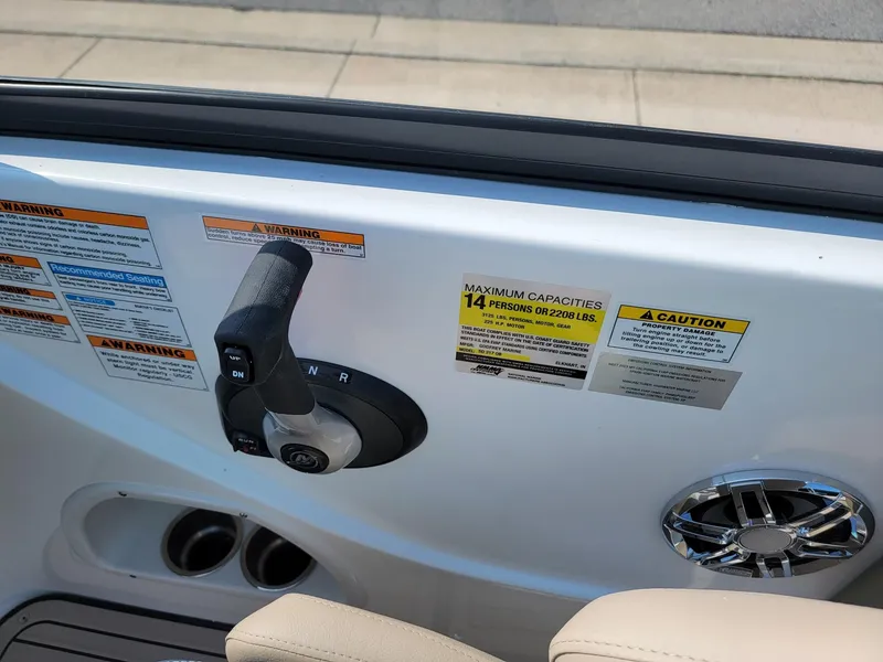 Slide: The Image of Control panel of 2024 Hurricane SunDeck 217 OB boat with capacity and warning labels. - 14