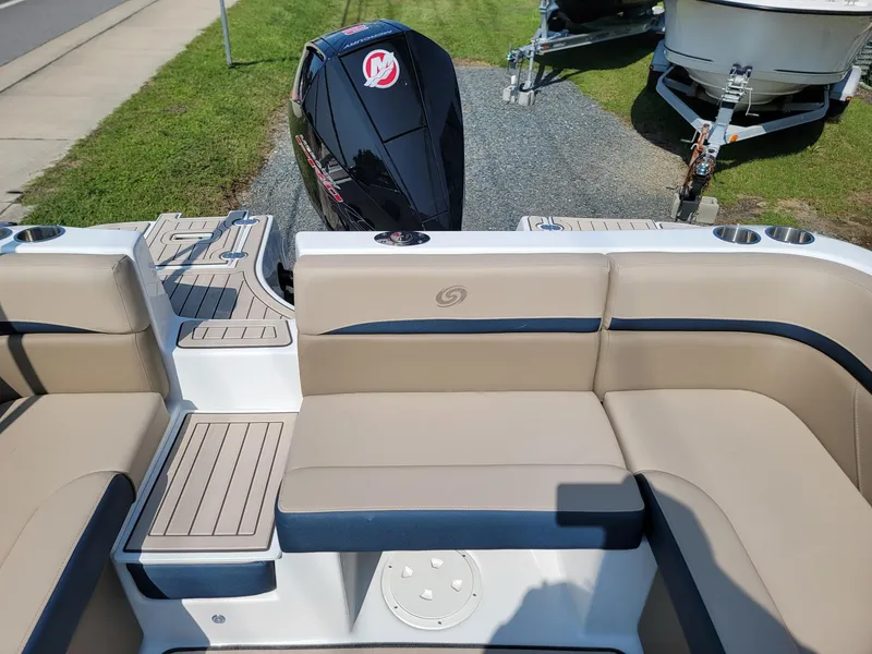 Slide: The Image of 2024 Hurricane SunDeck 217 OB boat interior with tan seating and outboard motor. - 16