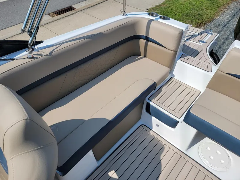 Slide: The Image of 2024 Hurricane SunDeck 217 OB boat with beige seating and deck. - 17