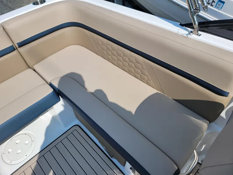Slide: The Image of 2024 Hurricane SunDeck 217 OB boat with beige and black cushioned seating. - 18