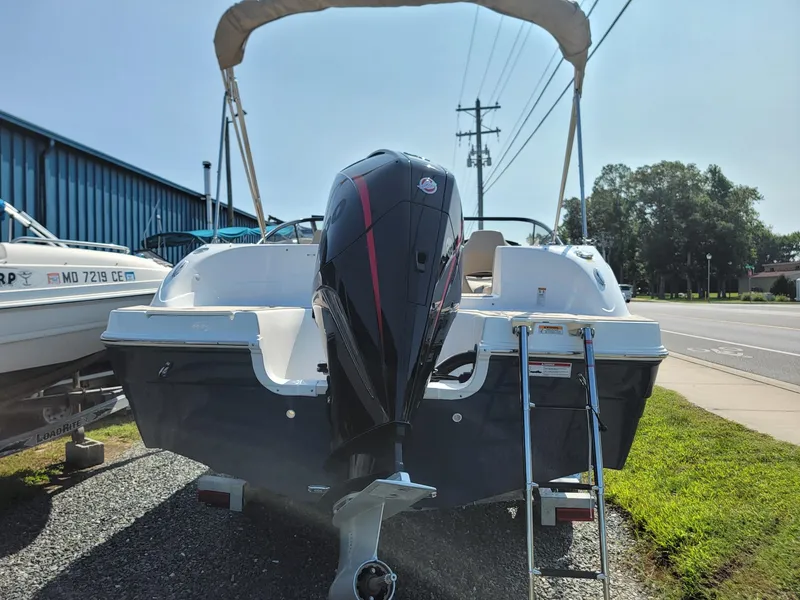 Slide: The Image of 2024 Hurricane SunDeck 217 OB boat with outboard motor and ladder. - 2