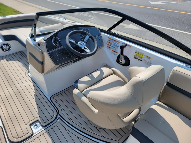 Slide: The Image of 2024 Hurricane SunDeck 217 OB boat interior with steering wheel and seating. - 24