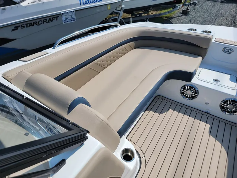 Slide: The Image of 2024 Hurricane SunDeck 217 OB boat with beige seating and deck. - 26