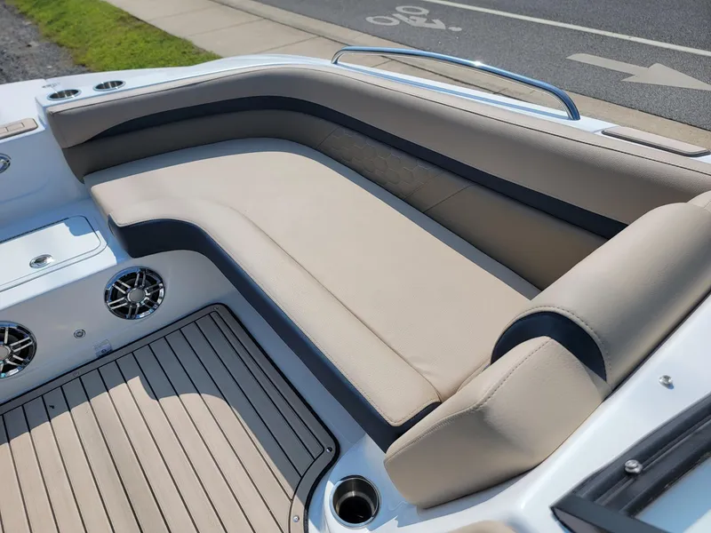 Slide: The Image of 2024 Hurricane SunDeck 217 OB boat with beige seating and deck speakers. - 27