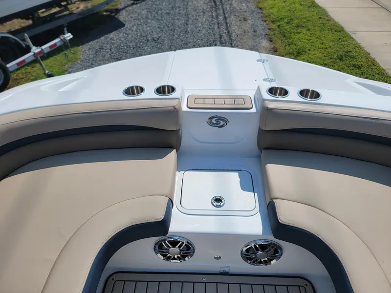 Slide: The Image of 2024 Hurricane SunDeck 217 OB boat interior with cushioned seating and cup holders. - 28