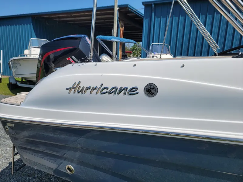 Slide: The Image of 2024 Hurricane SunDeck 217 OB boat side view with logo. - 29
