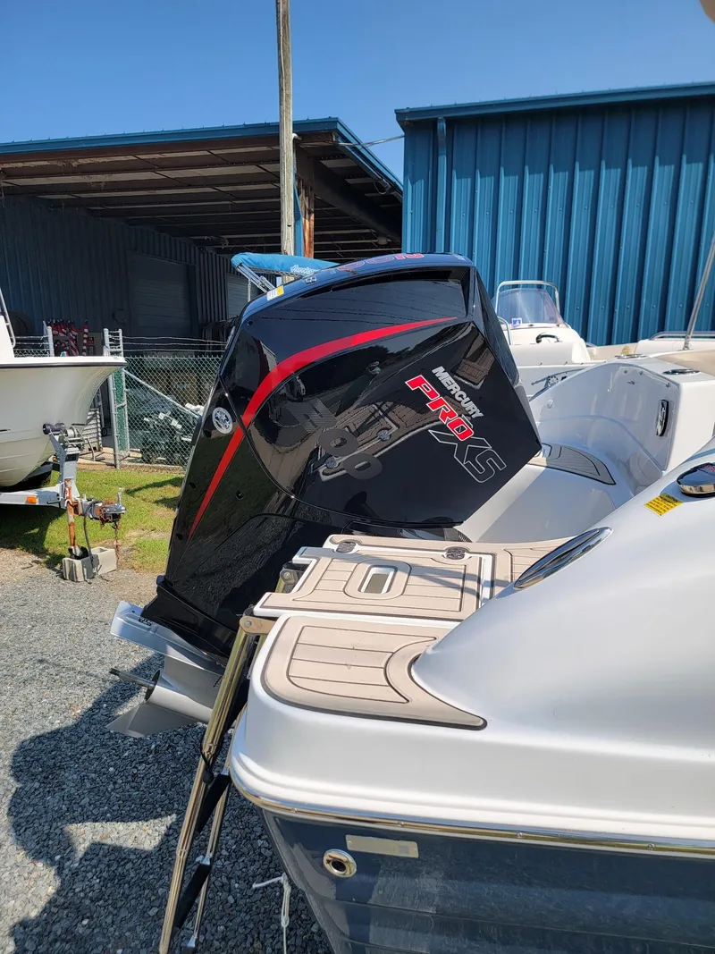 Slide: The Image of 2024 Hurricane SunDeck 217 OB boat with powerful outboard motor. - 31