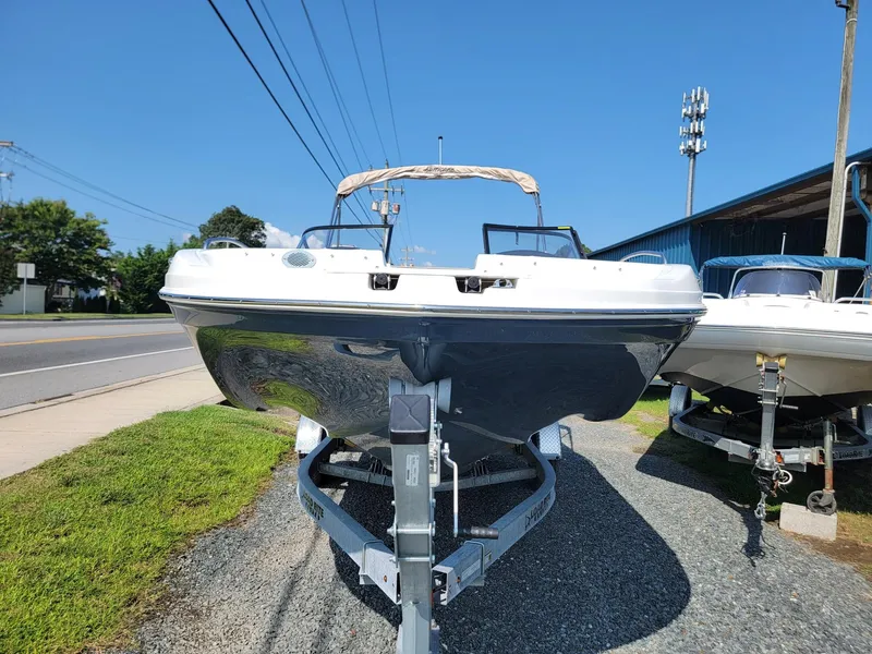 Slide: The Image of 2024 Hurricane SunDeck 217 OB boat on a trailer, front view. - 5