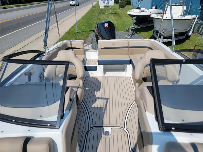 Slide: The Image of 2024 Hurricane SunDeck 217 OB boat with spacious seating and modern design. - 6