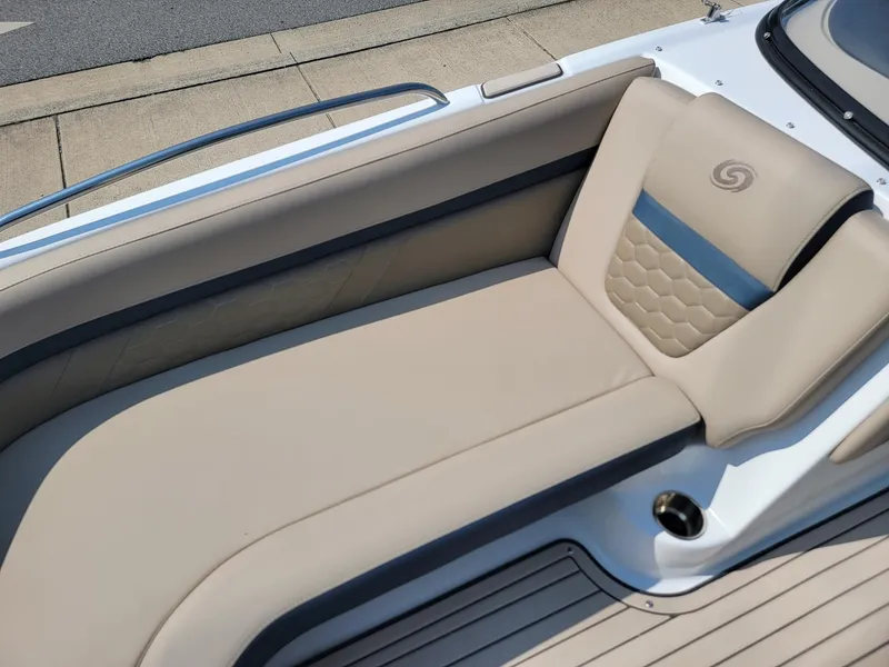 Slide: The Image of 2024 Hurricane SunDeck 217 OB boat with beige cushioned seating. - 7