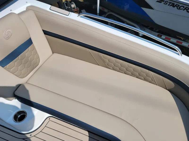 Slide: The Image of 2024 Hurricane SunDeck 217 OB boat with beige and black cushioned seating. - 8