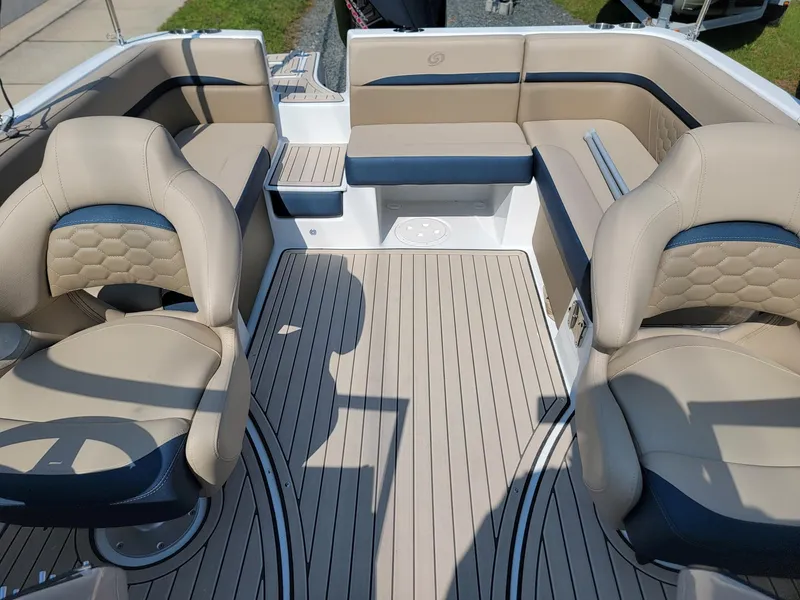 Slide: The Image of 2024 Hurricane SunDeck 217 OB boat interior with beige and navy seating. - 9