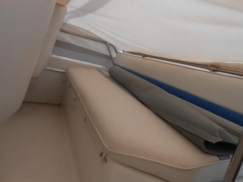 Slide: The Image of 1989 Chris-Craft Amerosport 320 interior with beige seating and rolled-up cover. - 11