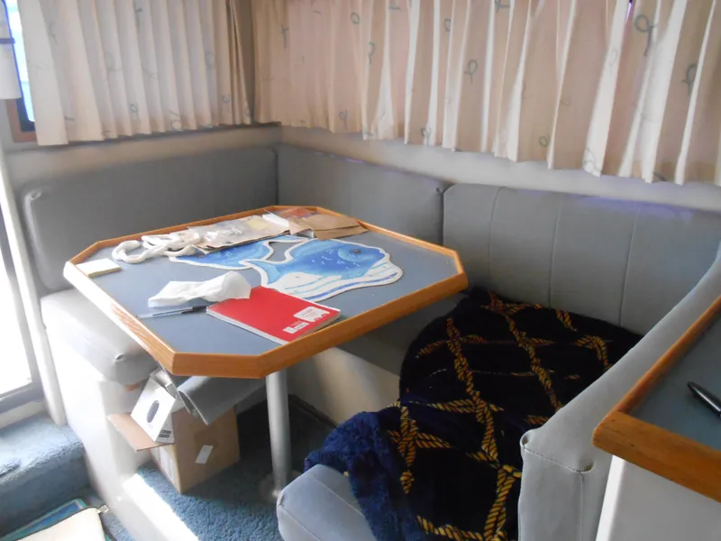 Slide: The Image of 1989 Chris-Craft Amerosport 320 interior with dining area, table, and seating. - 14
