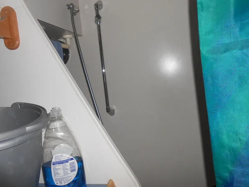 Slide: The Image of 1989 Chris-Craft Amerosport 320 interior with cleaning supplies and shower area. - 16