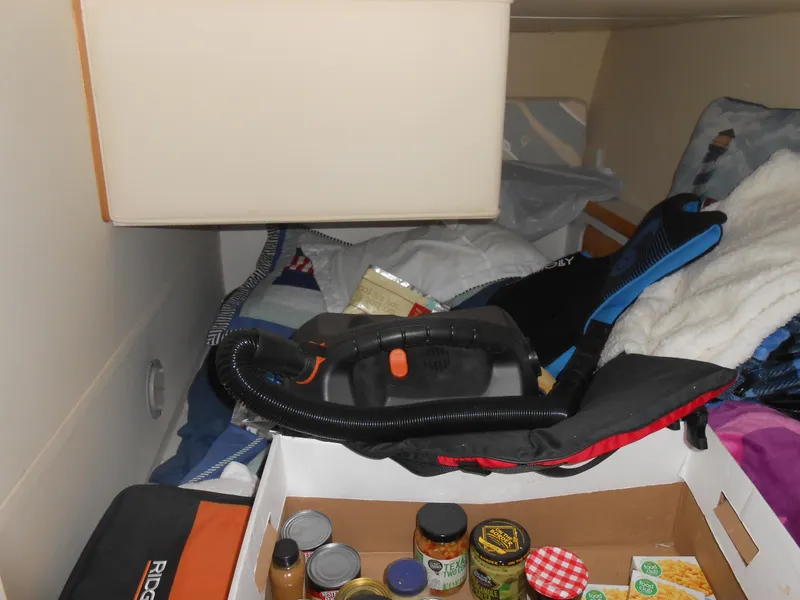 Slide: The Image of Storage area inside 1989 Chris-Craft Amerosport 320 with vacuum and canned goods. - 18