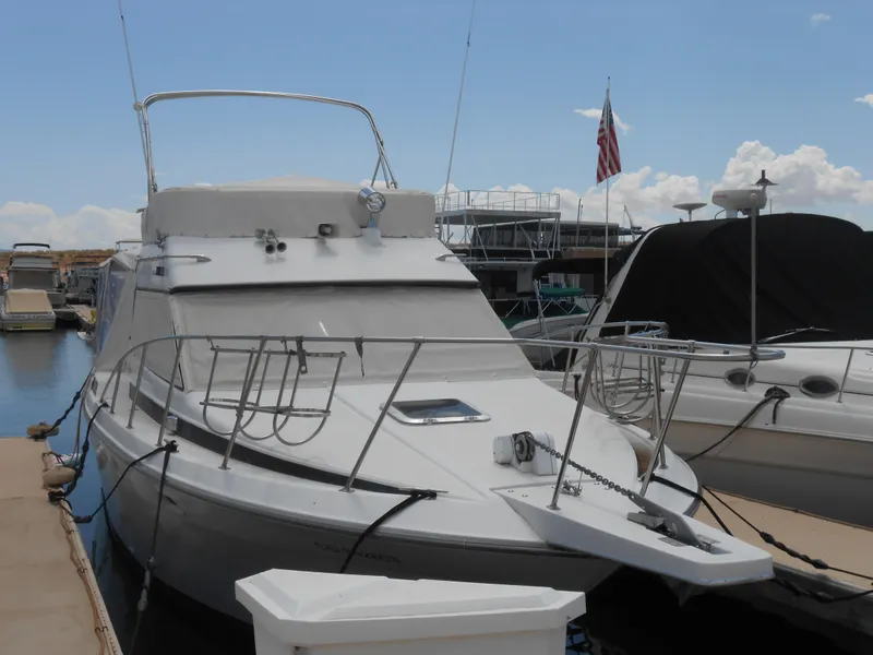 Slide: The Image of 1989 Chris-Craft Amerosport 320 docked at marina under clear sky. - 5