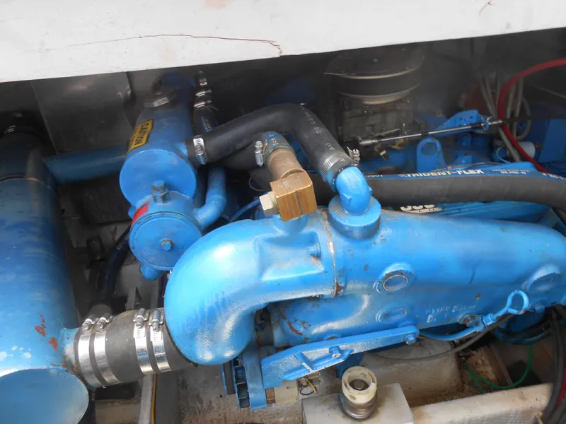 Slide: The Image of Engine compartment of 1989 Chris-Craft Amerosport 320, featuring blue components and hoses. - 7