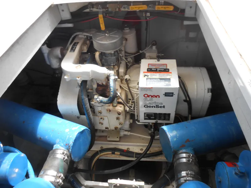 Slide: The Image of Engine compartment of 1989 Chris-Craft Amerosport 320 with Onan generator and blue hoses. - 8